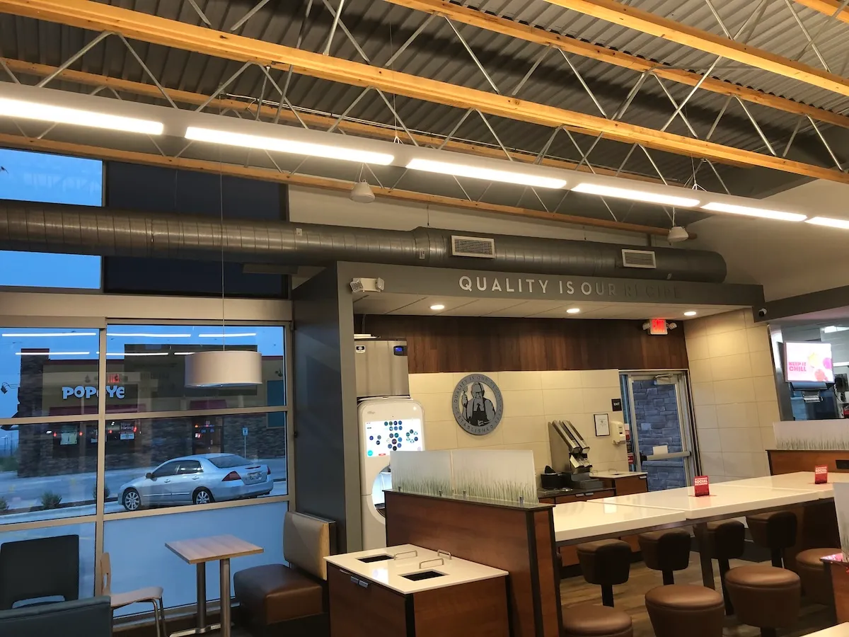 Restaurant dining room with exposed spiral supply duct along the ceiling